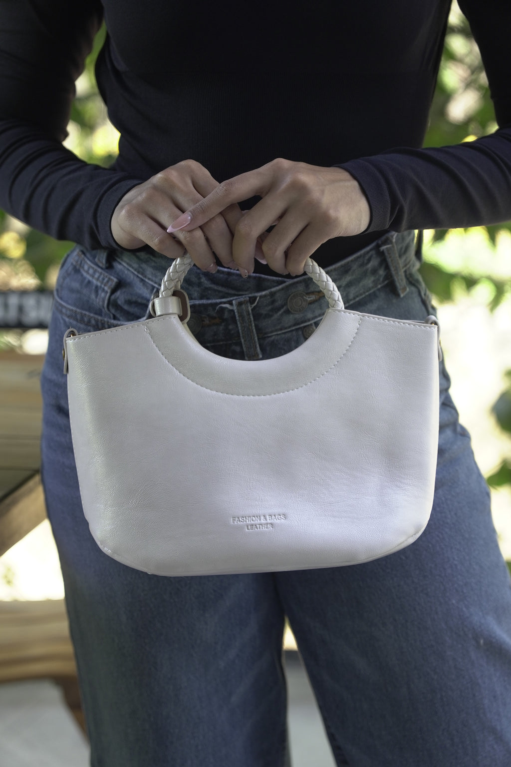 Detalle de bolso FRANCESCA marfil con asa trenzada en mano - CALÉA